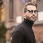 A fashionable man with glasses and a beard captured outdoors in Budapest.